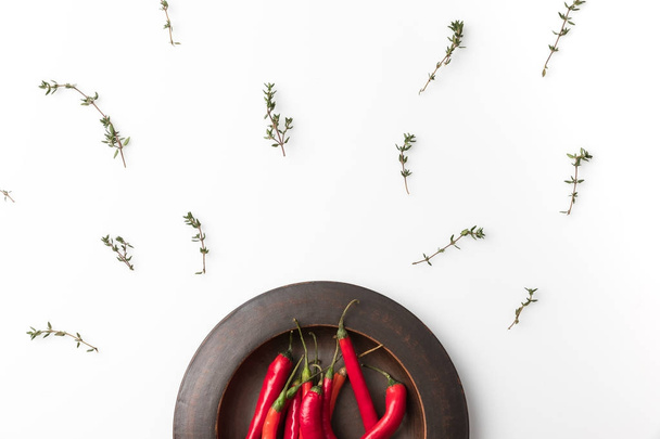 red chili peppers on black plate  - Φωτογραφία, εικόνα