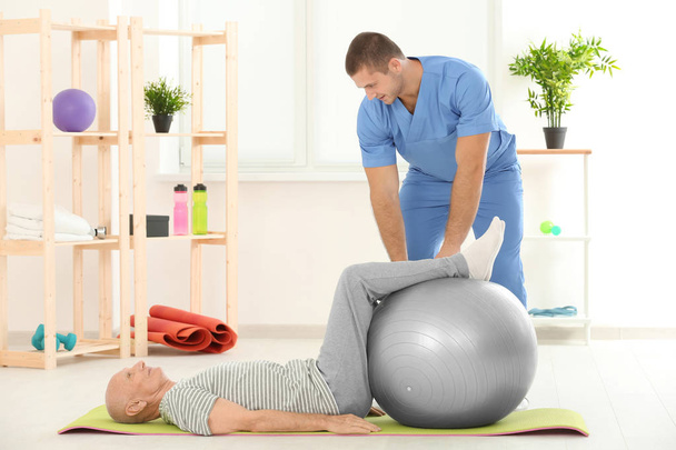 Physiotherapist working with patient in clinic - Photo, Image