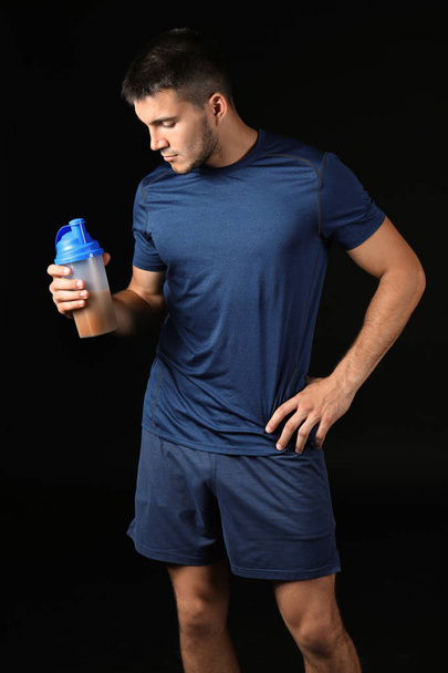 Handsome young man with protein shake - Фото, зображення