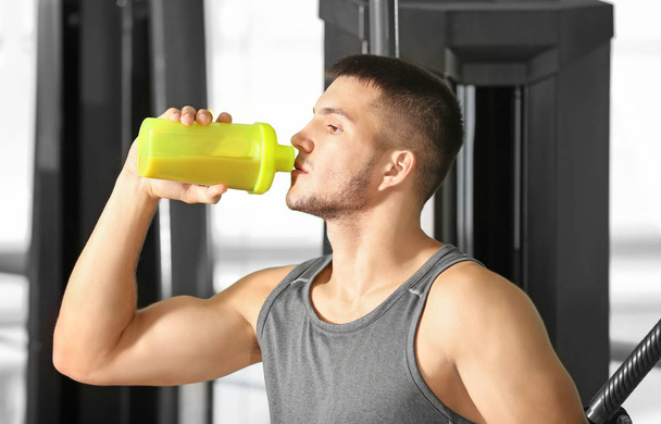 Handsome young man with protein shake - Foto, Imagen
