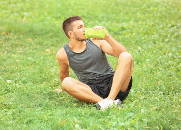 Handsome young man with protein shake - Foto, Bild