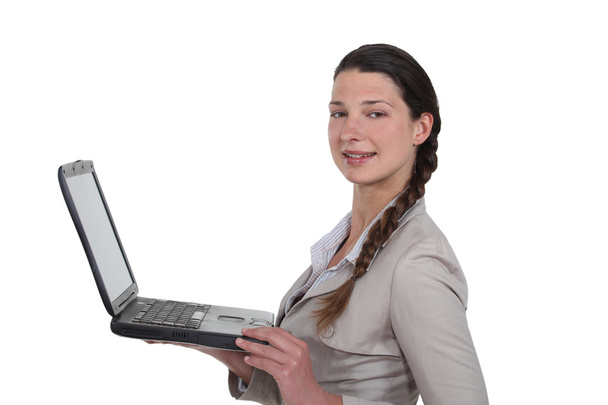 Young woman standing with laptop - Fotó, kép