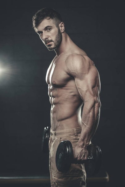 Attractive model young man training in gym - Фото, зображення