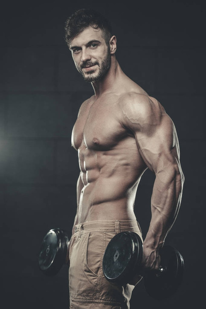 Attractive model young man training in gym - Фото, изображение