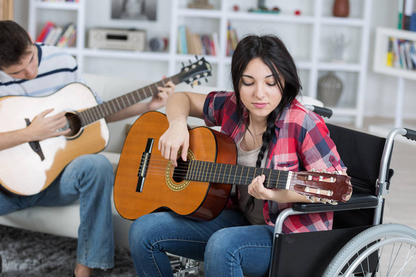 young disabled girl playing guitar - Fotó, kép