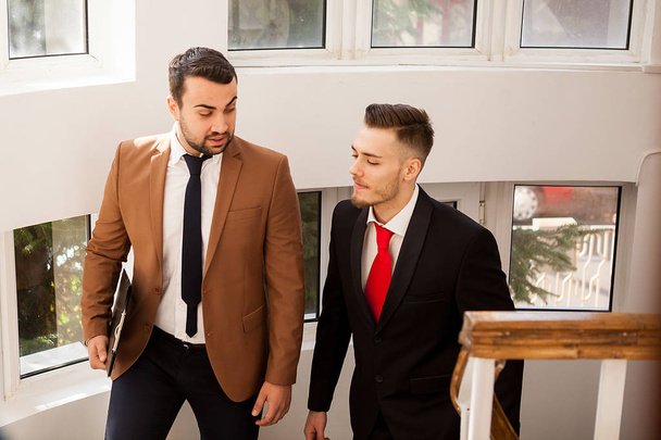 Business partners in formal suit walking and talking - Foto, imagen