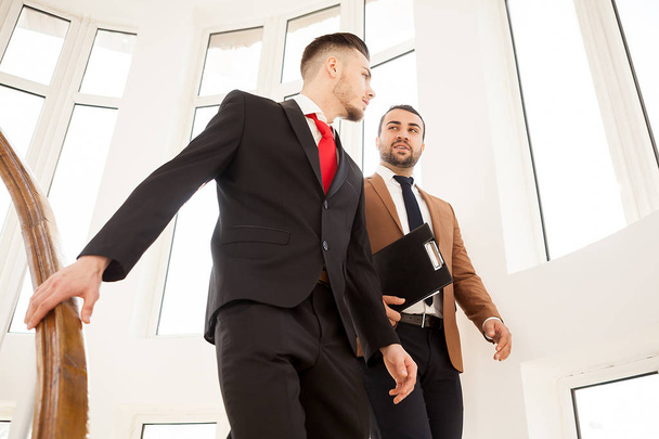 Business partners in formal suit walking and talking - Photo, Image