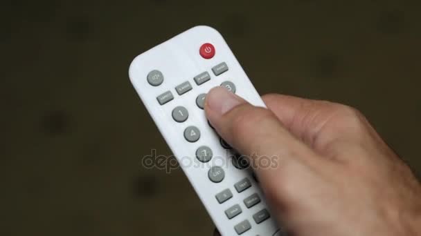 Man holds the TV remote control - Footage, Video