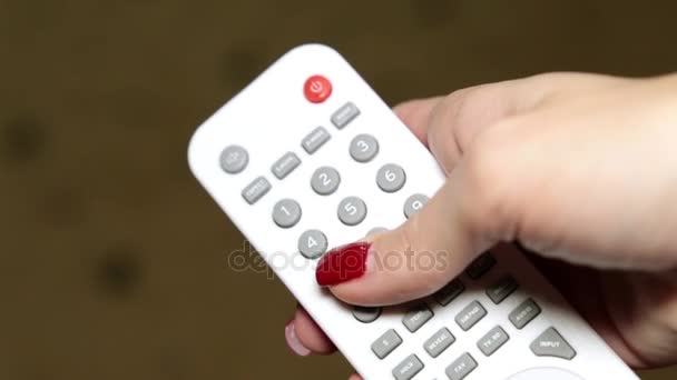 Woman and TV remote control - Footage, Video