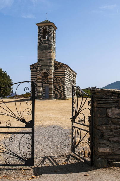 Corsica: view of the Church of San Michele de Murato, a small chapel built in the 12th century in polychrome stones and typical Pisan Romanesque style in the Haute-Corse village of Murato - Photo, Image