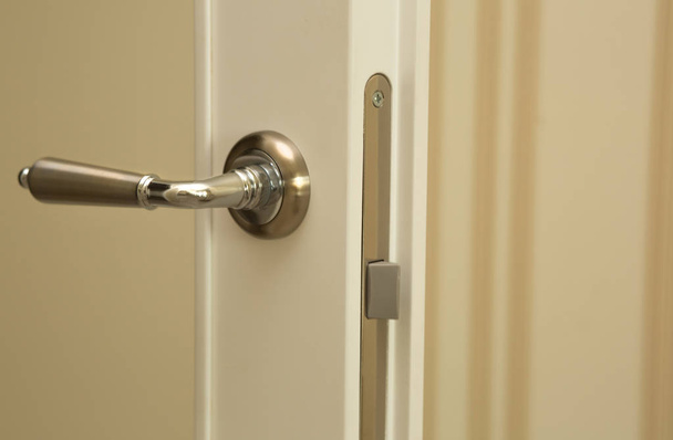 Closeup shot of beige partition door handle. Empty space - Photo, Image