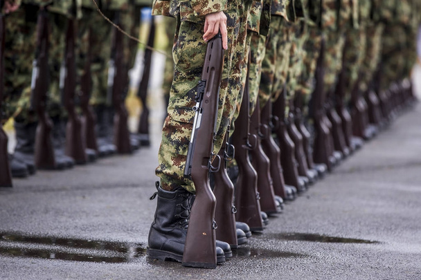 Soldiers stand in row. Gun in hand. Army, Military Boots lines o - Photo, Image