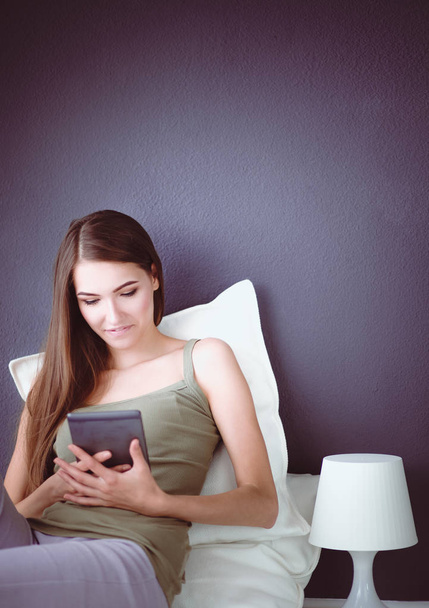 Woman with pc tablet is isolated on grey background - Zdjęcie, obraz
