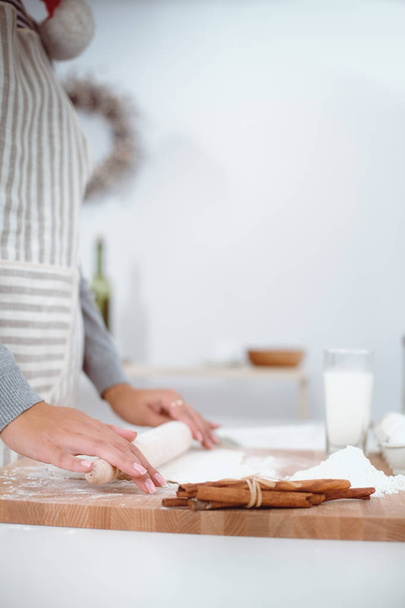 Woman making christmas cookies in the kitchen - Фото, изображение