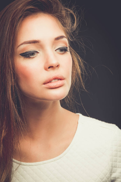 Beauty. Portrait of a young woman on dark background - Fotografie, Obrázek
