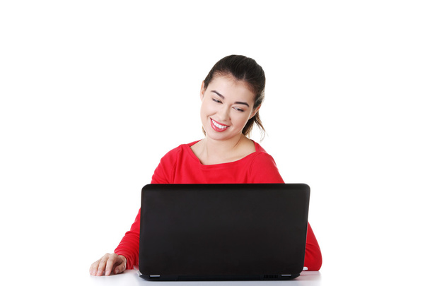 Happy young woman using her laptop. - Fotó, kép