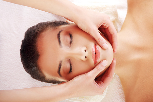 Relaxed woman enjoy receiving face massage - Foto, Imagem