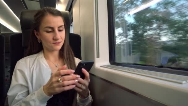 A Young Lady Using a Smartphone in the Train. - Video