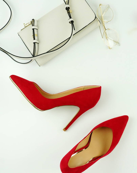 Female fashionable stylish accessories red shoes with heels, white bag and glasses on a white background - Φωτογραφία, εικόνα