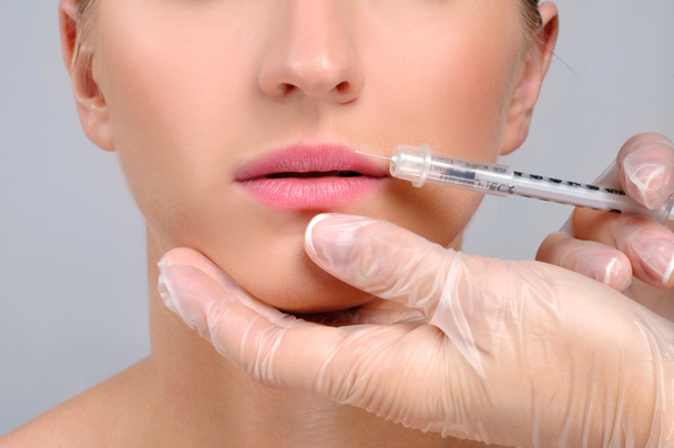 Woman is getting botox injection n lips. Cosmetic Treatment and Plastic Surgery - Photo, Image