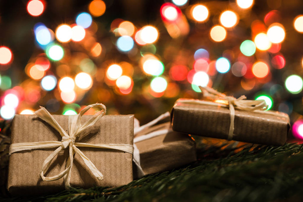 Christmas eve background, vintage gift boxes and lights in blurred colors - Fotografie, Obrázek