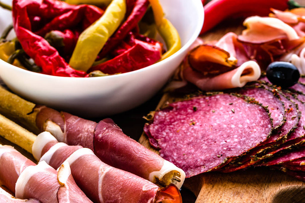 Cold meat platter with salami, slices ham prosciutto, italian antipasti on wooden board - Foto, immagini