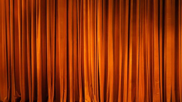 The yellow curtain. Theatrical scenes with light from the spotlights in the closed position - Photo, Image