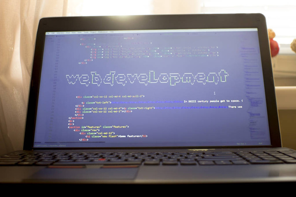 Web development phrase ASCII art inside real HTML code. Web developing concept on screen. Abstract information technology modern background. Digital art. Code is created by myself. - Photo, Image