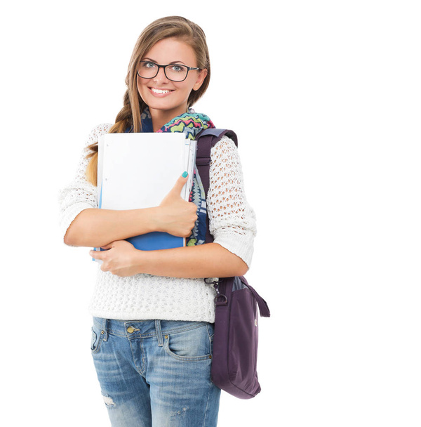 Portrait of a young student woman holding exercise books. - Foto, immagini