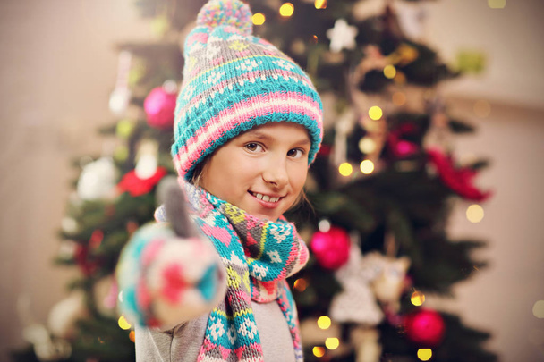 Happy girl posing with presents during Christmas time - Photo, image