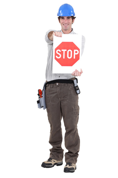 Portrait of craftsman holding stop sign - Foto, immagini