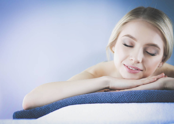 Young woman lying on a massage table,relaxing with eyes closed. Woman. Spa salon - Φωτογραφία, εικόνα