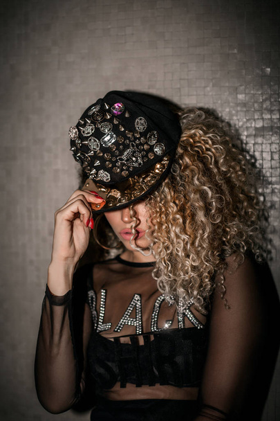Beautiful woman portrait with gorgeous hair wearing hip hop cap - Foto, Imagen