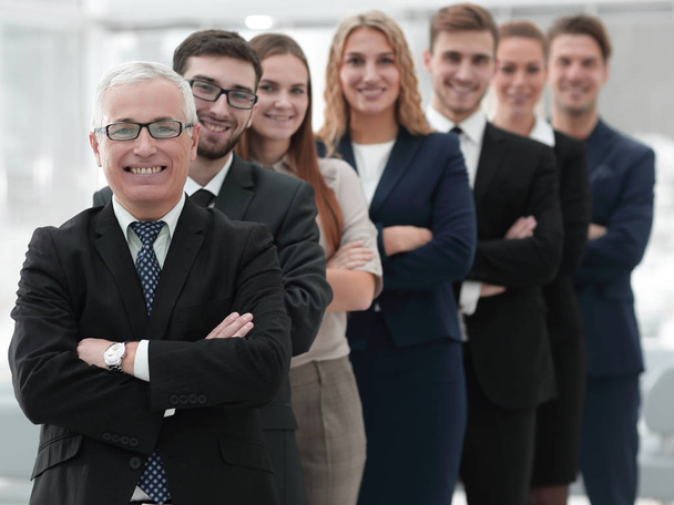 senior businessman standing in front of his business team - Photo, Image