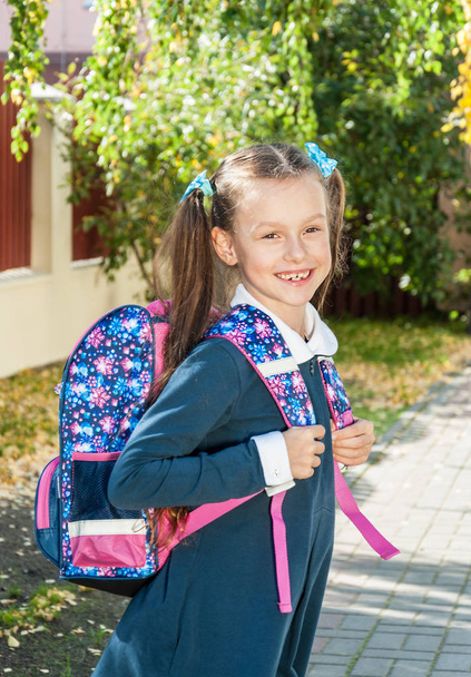 Happy little girl with a school bag outdoor  - 写真・画像