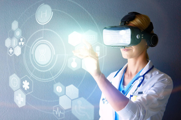 Female doctor wearing virtual reality glasses isolated on white background - Photo, image
