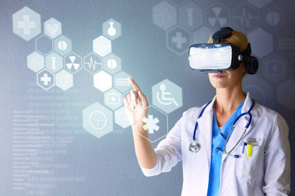 Female doctor wearing virtual reality glasses isolated on white background - Фото, изображение