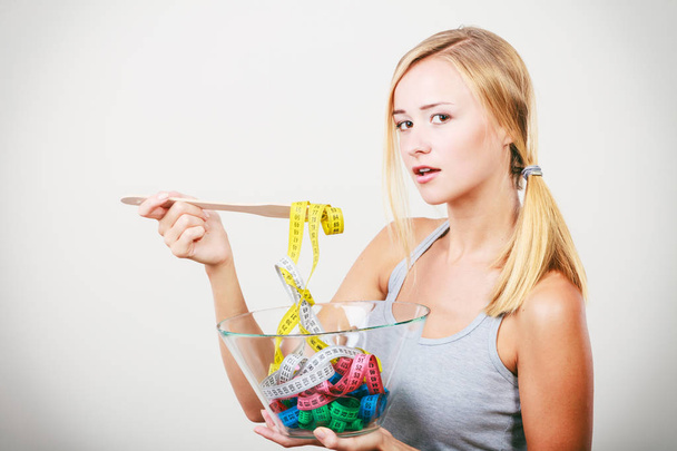 Diet. Girl with colorful measuring tapes in bowl - Zdjęcie, obraz