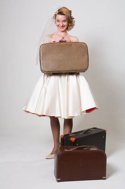Cheerful bride with suitcases - Fotoğraf, Görsel