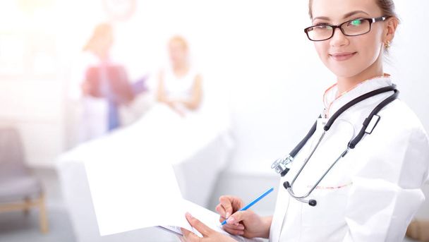 Young woman doctor standing at hospital with medical stethoscope - Photo, image