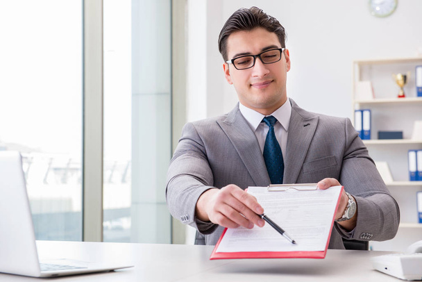 Businessman signing business documents in office - Photo, Image