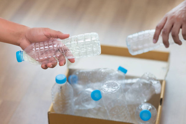 man hand putting plastic reuse  for recycling concept environmen - Фото, изображение