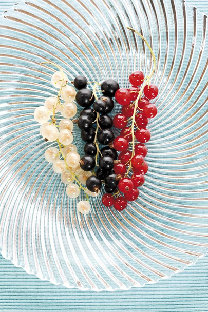 Red, white and black currants on a glass plate - Photo, Image