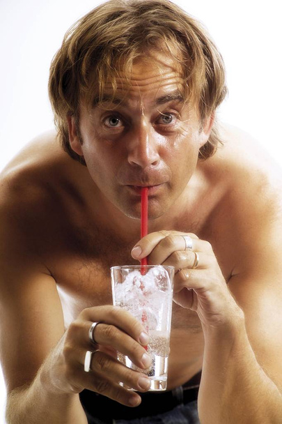 Shirtless man drinking a glass of water - Zdjęcie, obraz