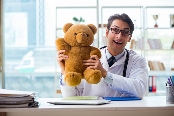 Pediatra con juguete sentado en la oficina - Foto, imagen