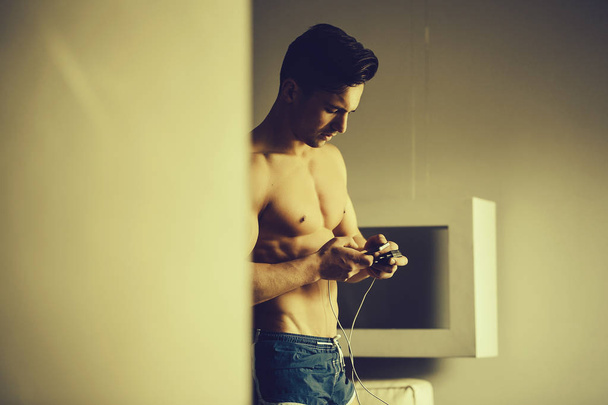 Muscular man with mobile phone - Photo, image