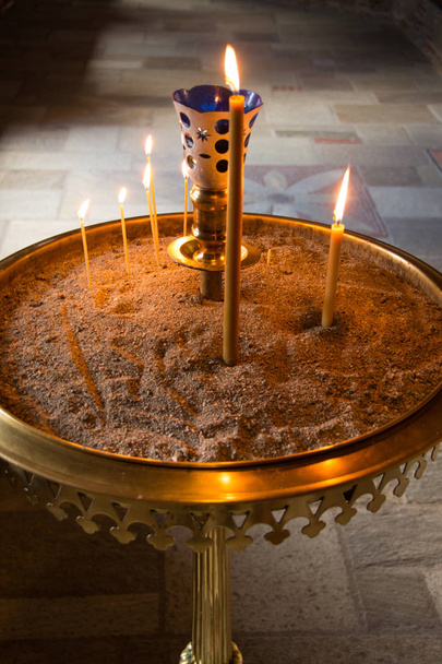Candles in sand in the Christian Church  - Photo, Image