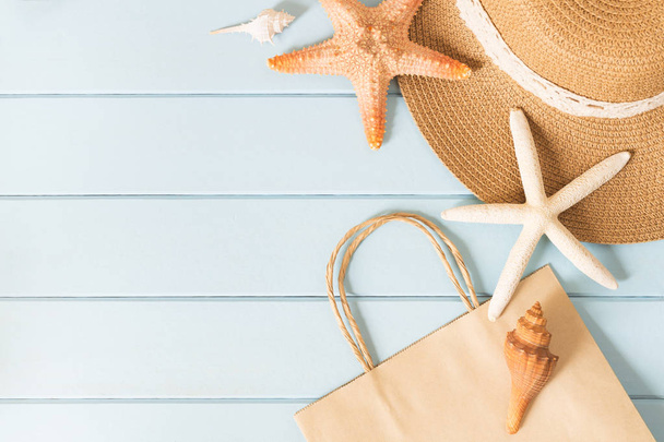 Paper bag,hat and starfish on a blue background - Zdjęcie, obraz