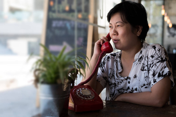 Asian women happy talk phone call in coffee shop - Photo, Image