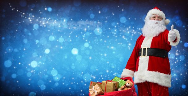 Santa Claus with a bag full of presents - Фото, зображення